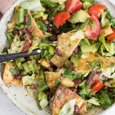 How to make Fiesta Fattoush Salad with fried flour tortillas, black beans, and homemade cilantro lime dressing. Easy weeknight dinner packed with veggies.