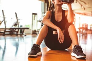 5 ways turmeric can help you make the most out of your workout woman drinking water and recovering after exercise