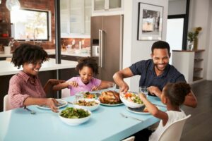 family having meal sat at the table health rituals