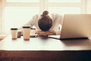 workplace overwhelm woman overworked at desk
