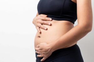 Woman holding bloated stomach