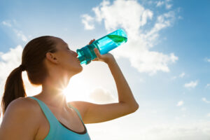 6-steps-to-create-your-ideal-summer-workout-routine-woman-drinking-water.jpg