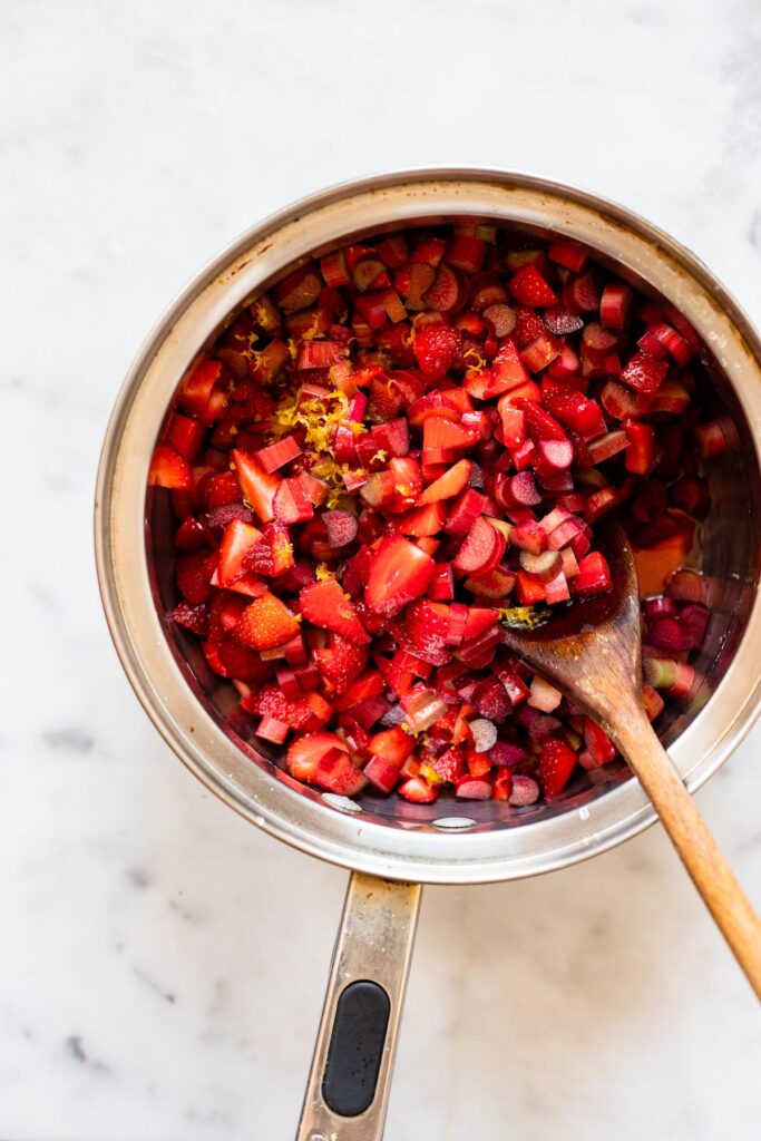 add chopped fruit, maple, and lemon to a saucepan.