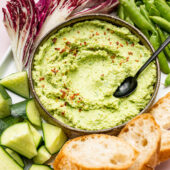 edamame sesame dip in bowl with spoon and vegetables