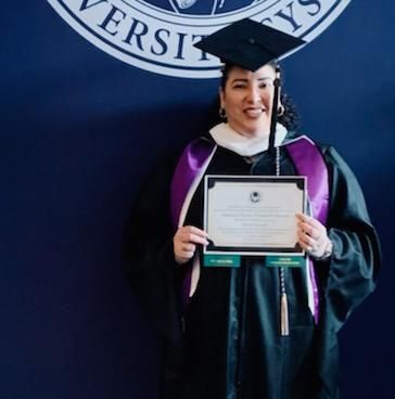 Natalie Chambers receiving her masteru2019s degree in legal studies, 2022. 
