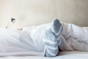 sleep tips woman in fluffy socks
