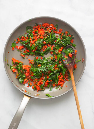 skillet with sautéed spinach and peppers. 