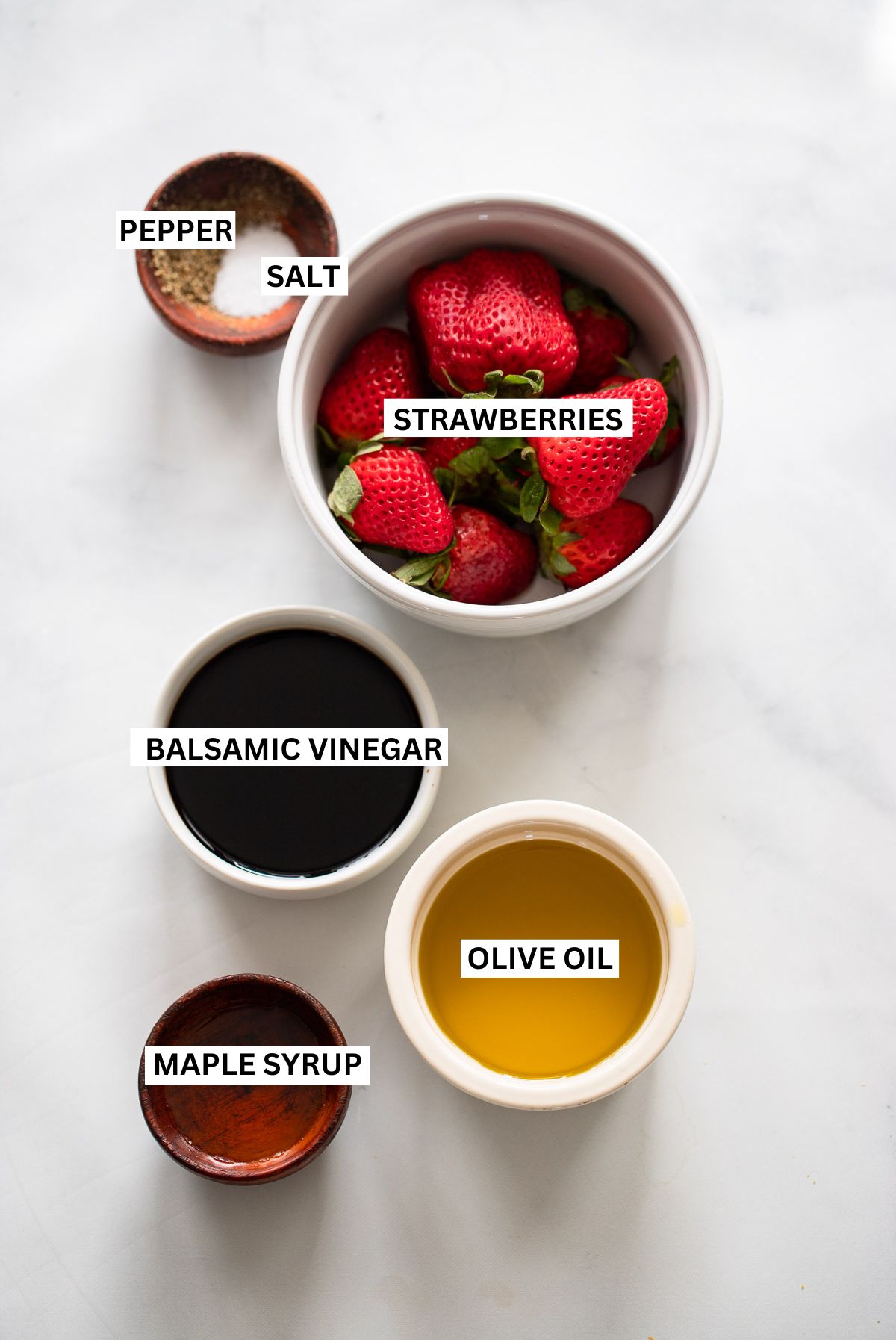 strawberry balsamic dressing ingredients in small bowls on white background with text overlay labels.