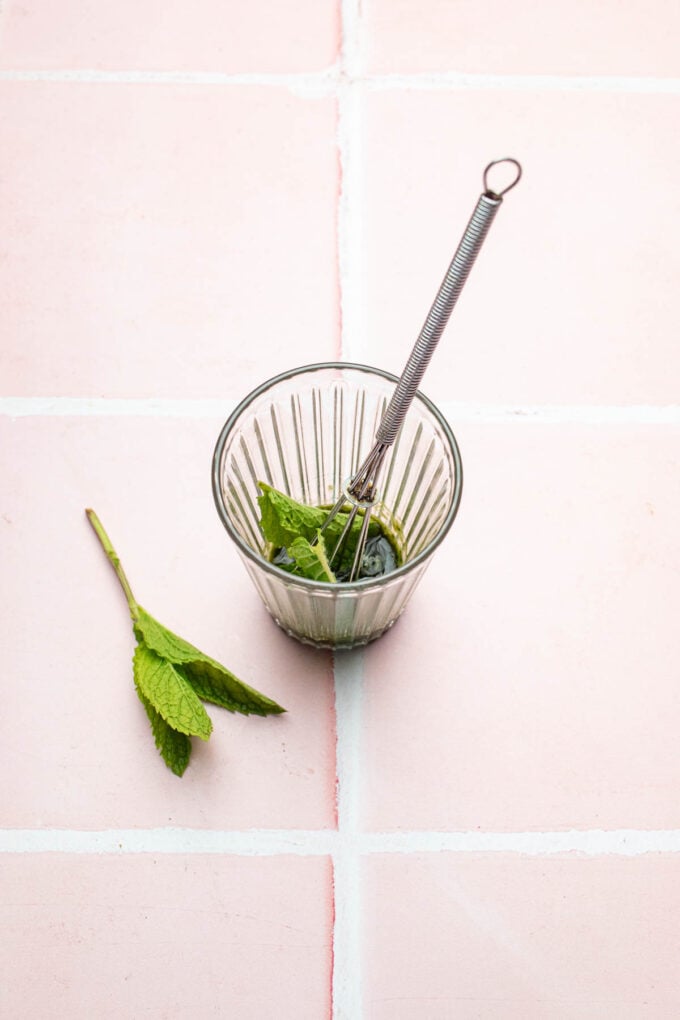 whisk with mint and glass