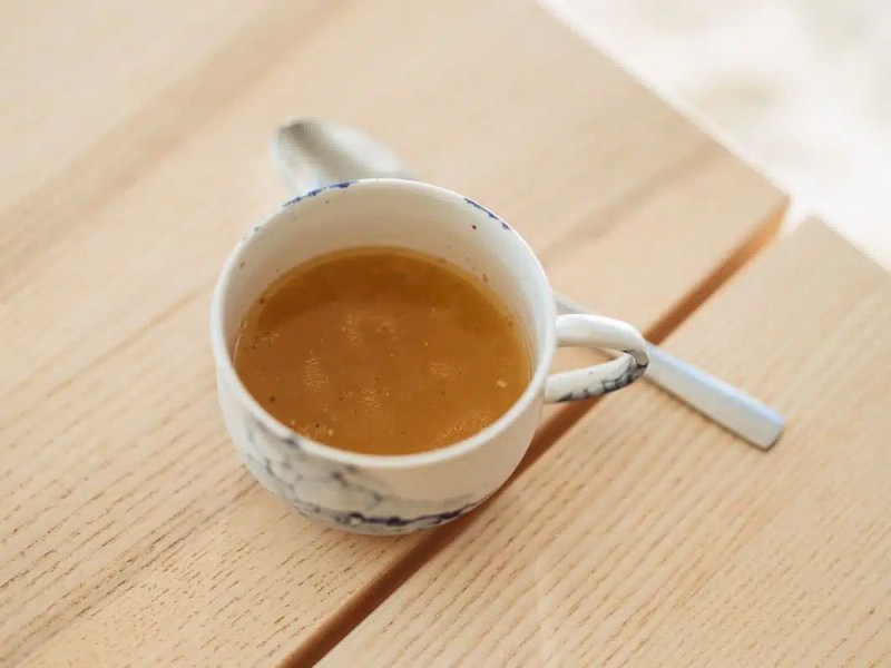 Cup of bone broth for dirty fasting