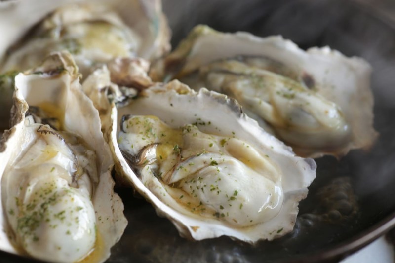 Grilled oysters with shells in butter and soy sauce