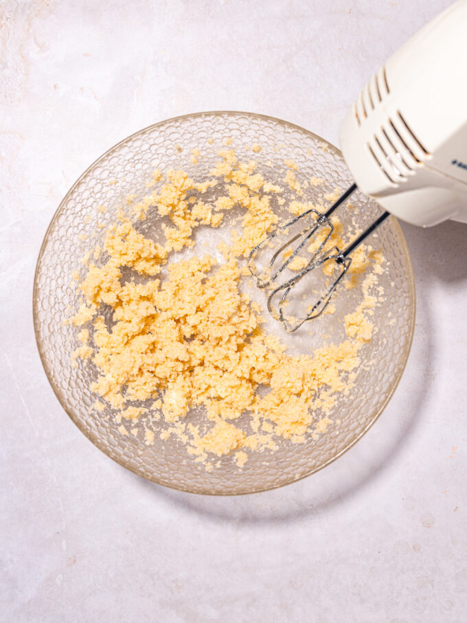beaters with butter and sugar mixture in bowl