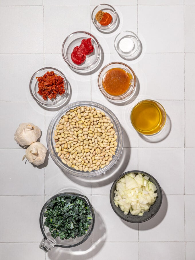 dried white beans, kale and tomato in bowls